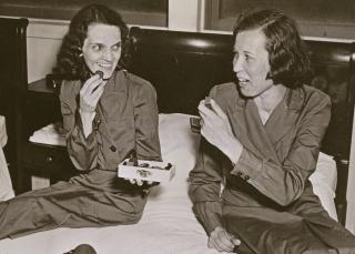 Lieutenant Nash (left) and fellow Navy nurse Bertha Evans gingerly attempt to eat some candy